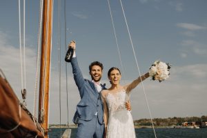 Newlyweds at their destination wedding in Finland celebrating with a bottle of champagne
