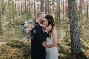 Bride and Groom sharing an intimate moment in the forest at their destination wedding in Sweden