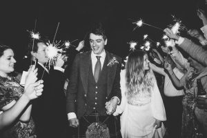 Bride wearing a Halfpenny London dress and groom at their sparkler exit on their wedding day in Edinburgh