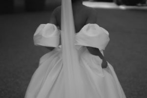 Bride holding her modern wedding dress in black and white