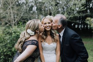 mum and dad of bride kissing her on each cheek before her luxury countryside wedding ceremony