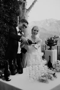 Bride and groom pouring a champagne tower at Ravello, Italy