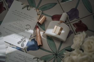 photo of wedding ring, perfume and lipstick
