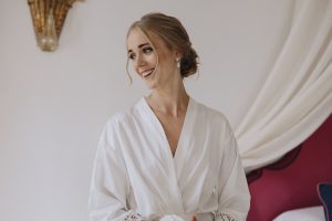 photo of the bride smiling in a white robe