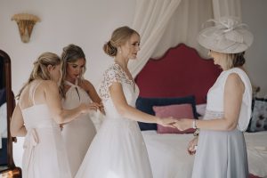 Bride getting into her Caroline Castigliano wedding dress