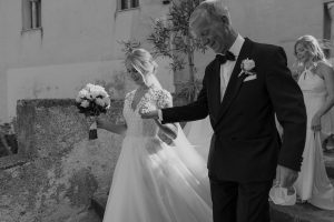 Bride walking with her dad through Ravello, Italy